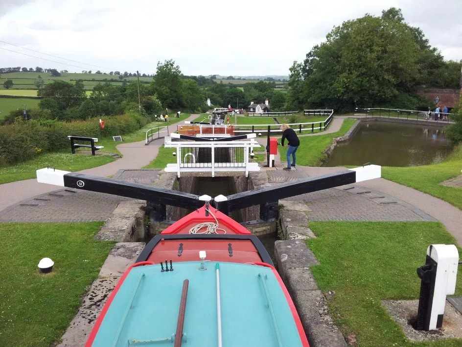 View from the bow of a boat waiting at the top of a lock flight with the gates ahead