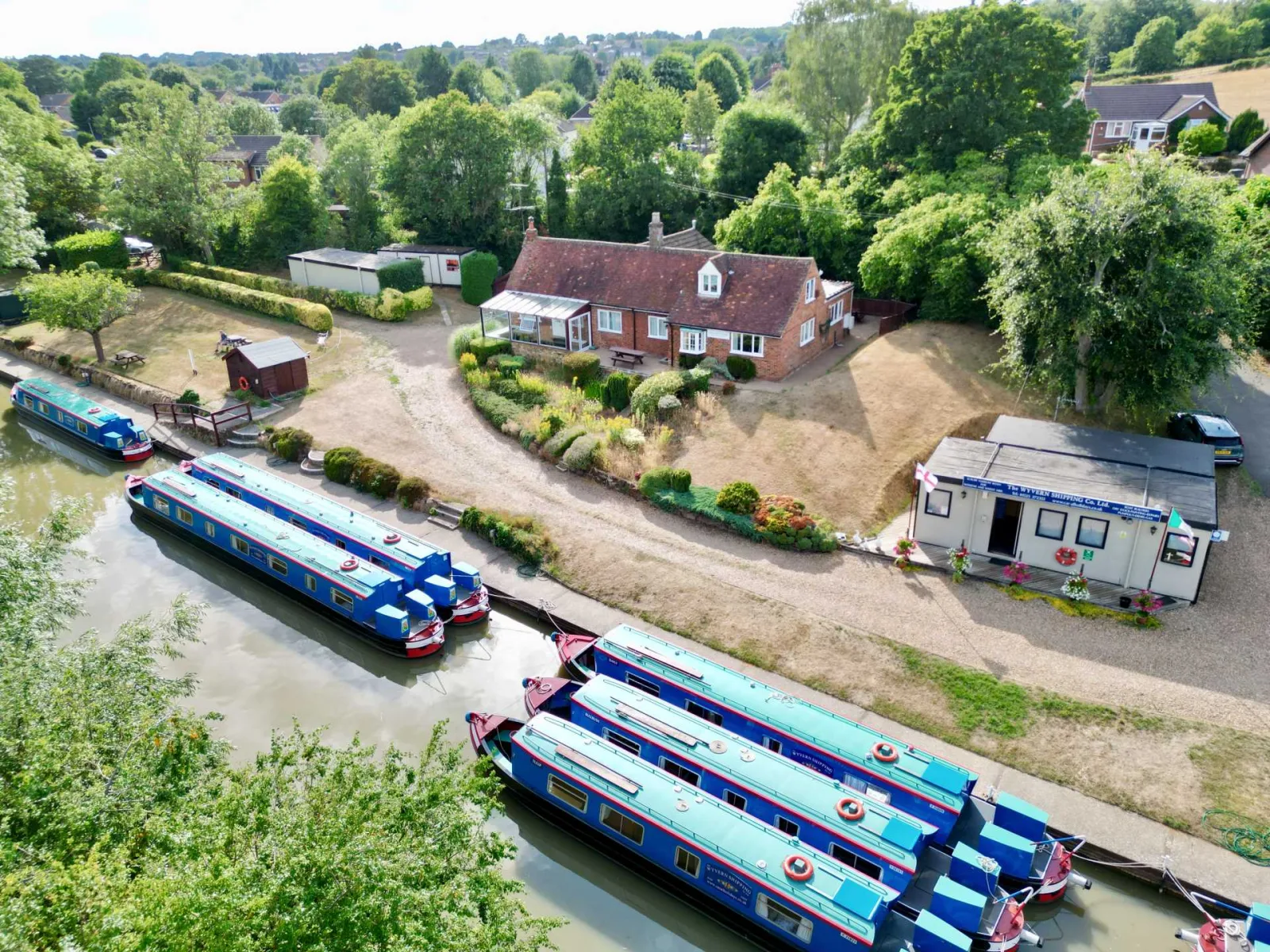 Aerial view of Waterside Cottage and the Wyvern boatyard with narrowboats moored alongside