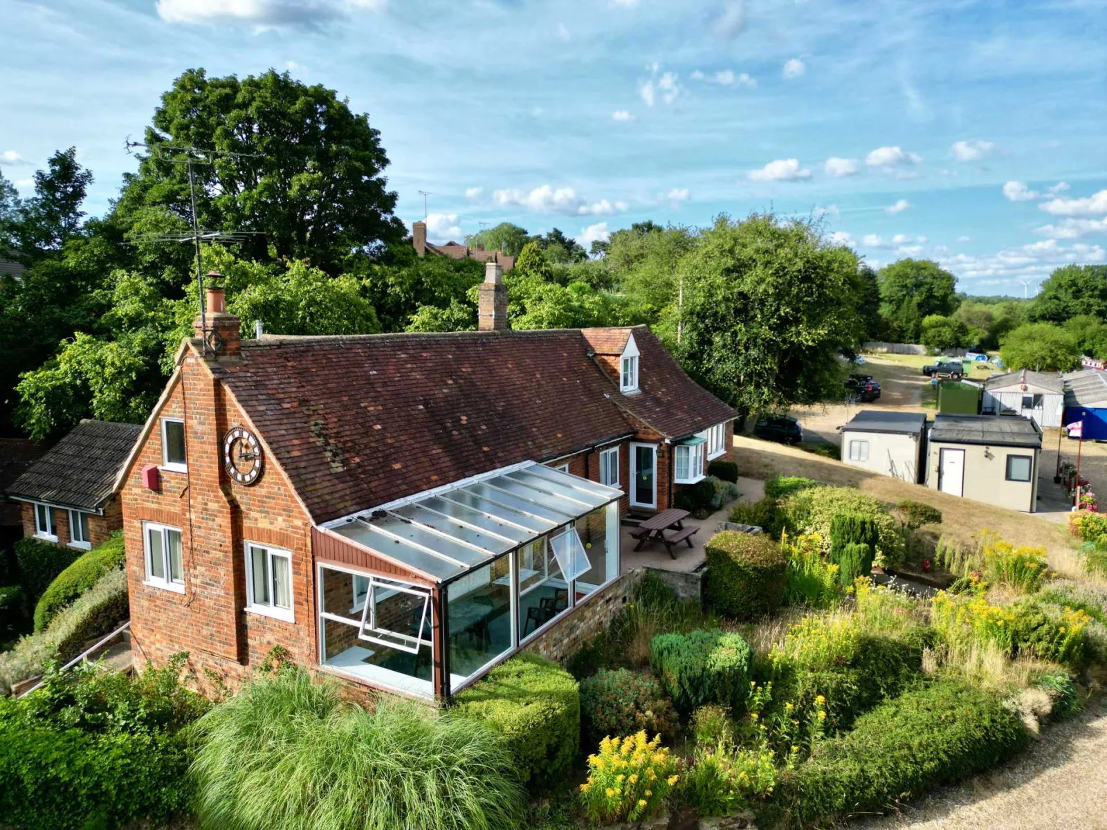 Waterside Cottage from above showing the conservatory and the garden running down to the canal